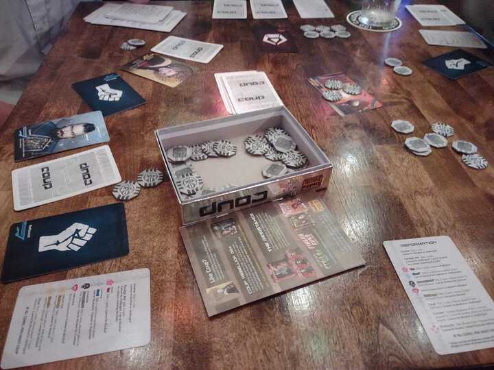 People playing the board game coup