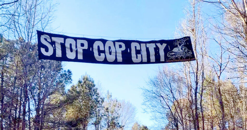 stop city banner over atlanta forest