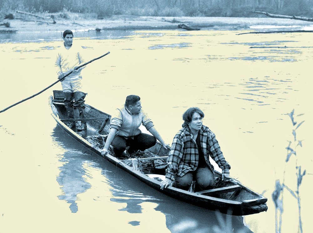 3 Indigenous people in a small boat, smoothly drifting through a river